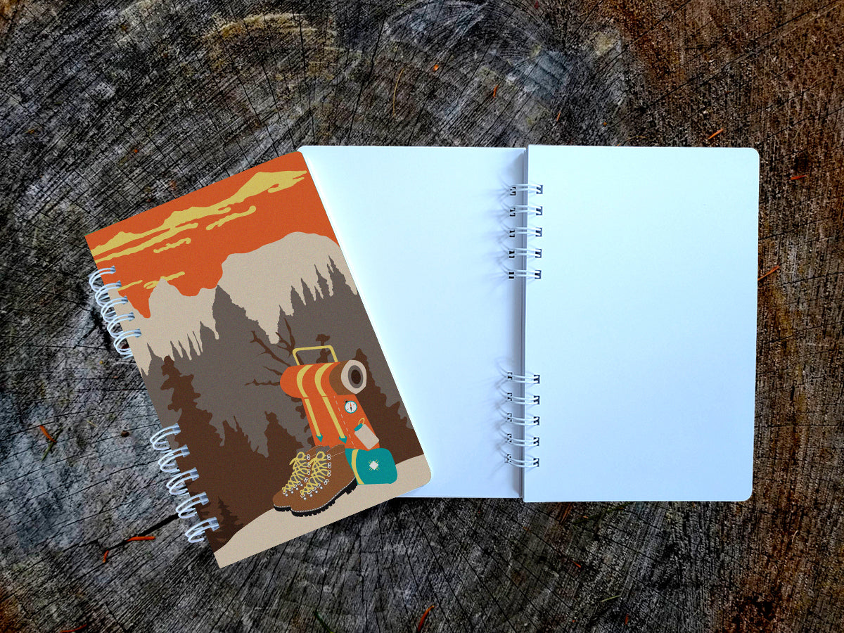 Notebook with illustration of hiking boots and a backpack