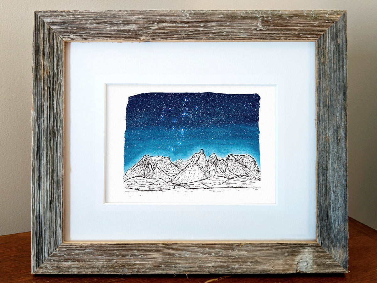 Framed art print of black and white mountains and a dark blue star filled sky