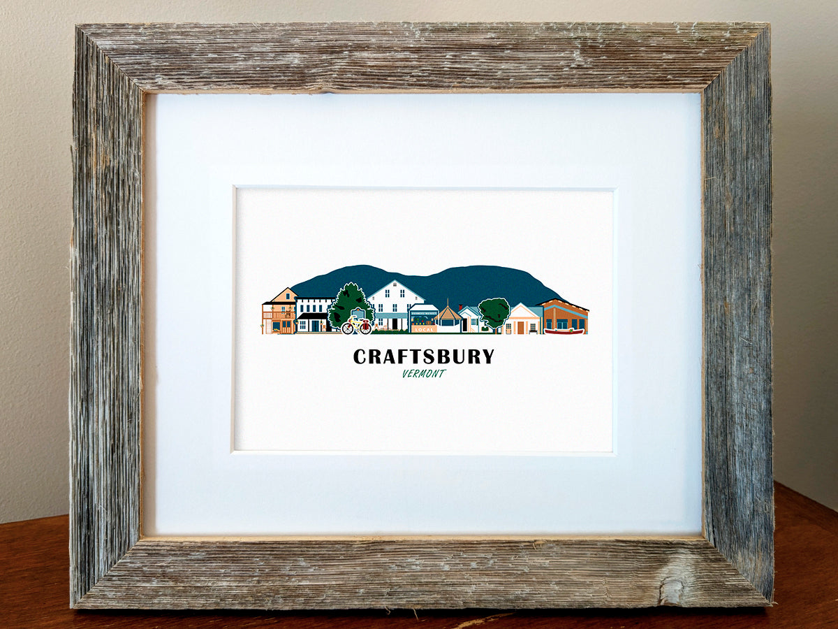 Framed art print of buildings arranged in a skyline with the text Craftsbury Vermont